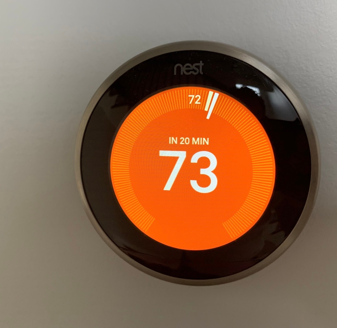 Modern smart thermostat mounted on an interior wall